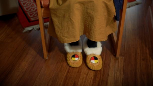 A pair of feet wearing moccasins