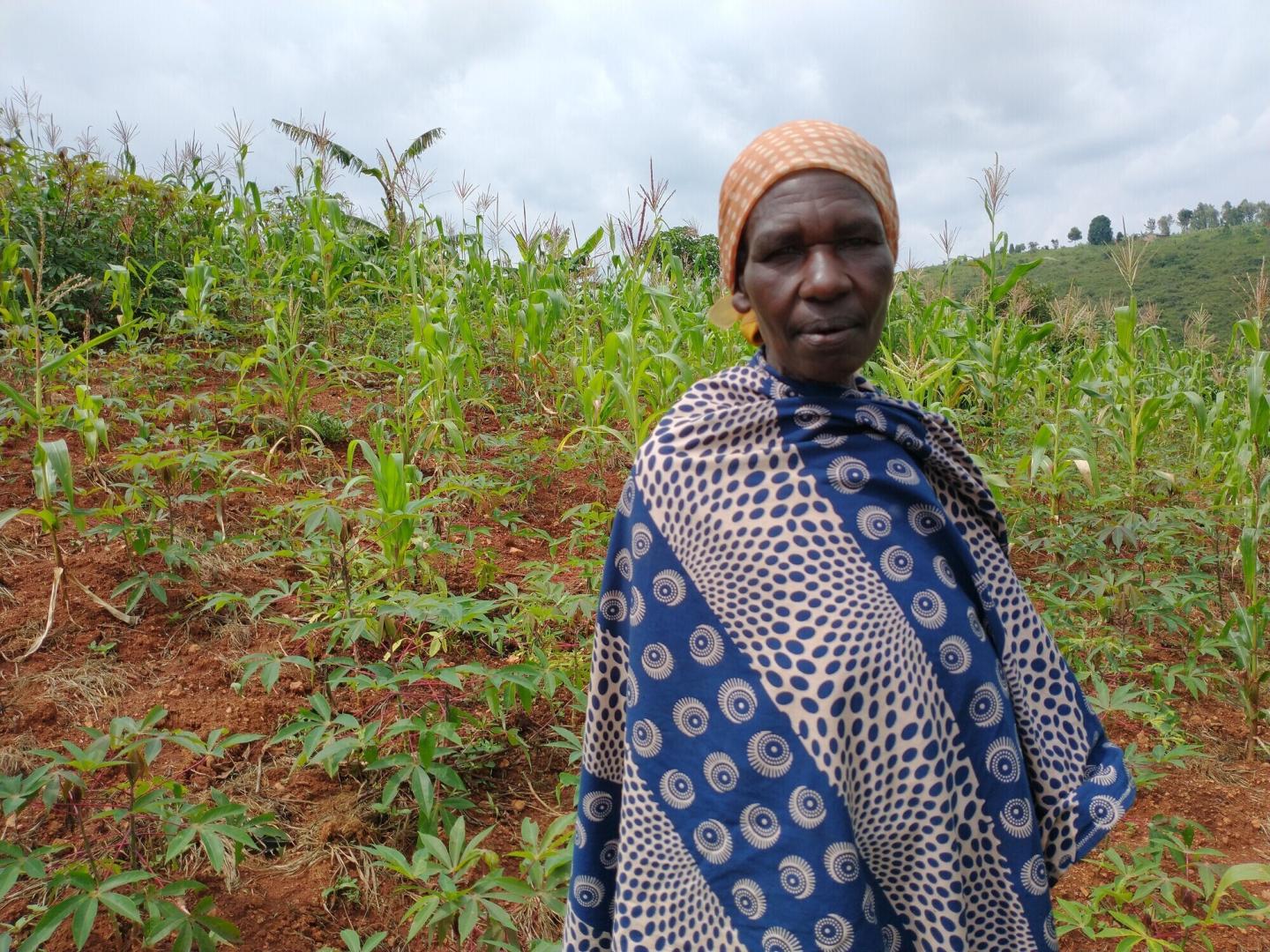 A Burundi woman stands in her field