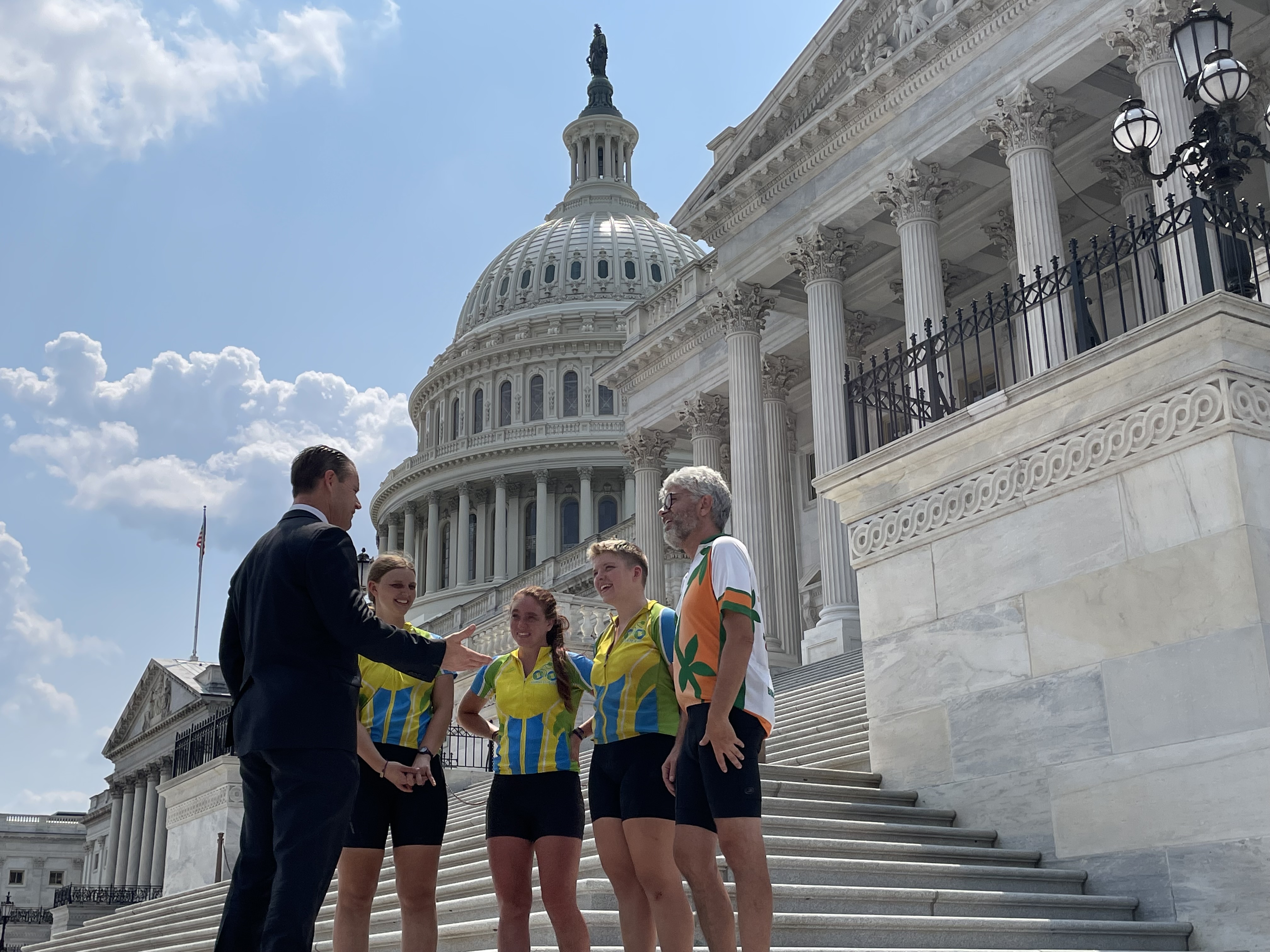 Four cyclists with the Center for Sustainable Climate Solutions meet with Senator Todd Young (R-Ind.) at the U.S. Capitol on July 28, 2021.