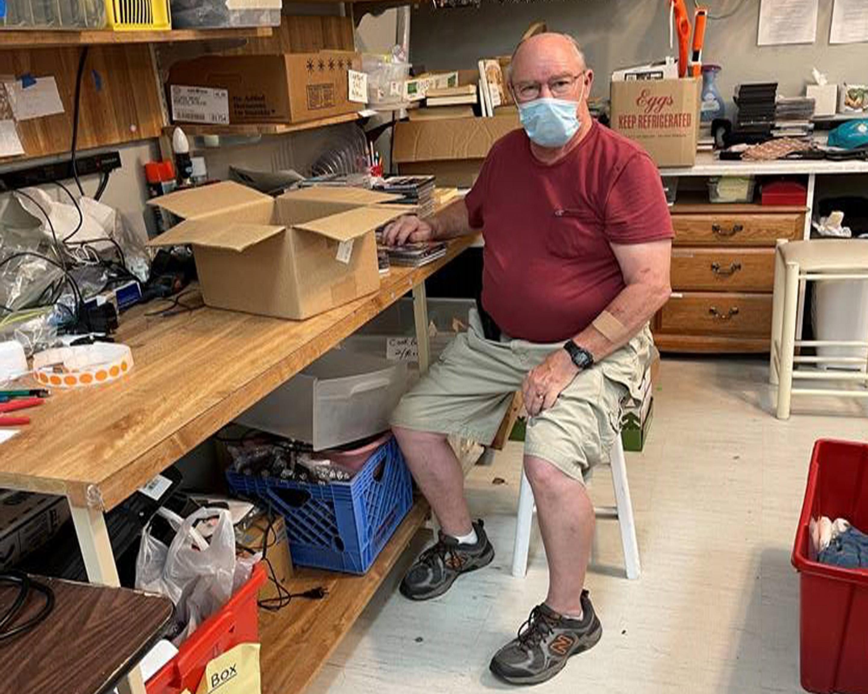 A man sitting a workbench