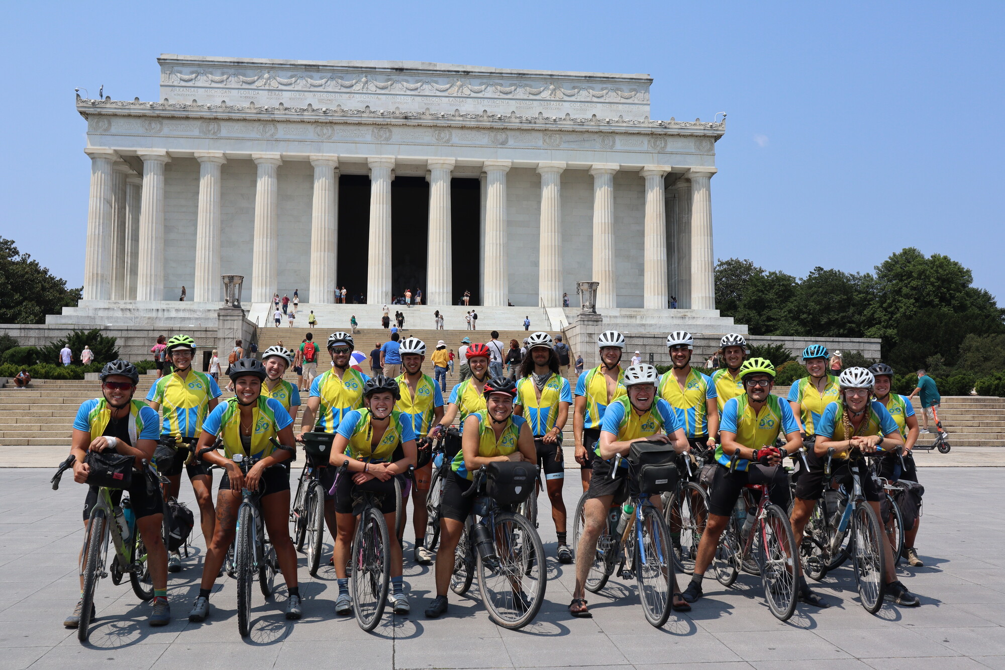 A group of cyclists standing in front of a US government building