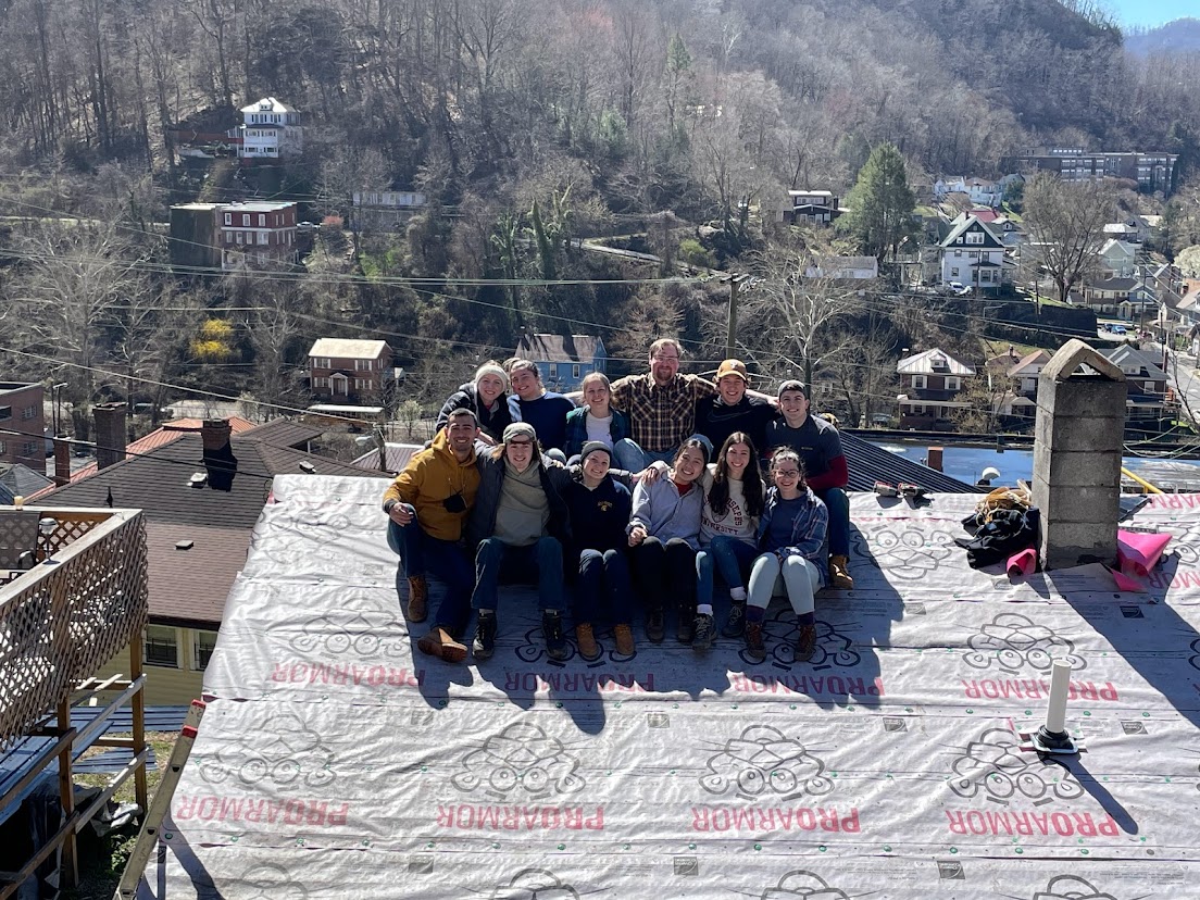 group of people sitting on roof
