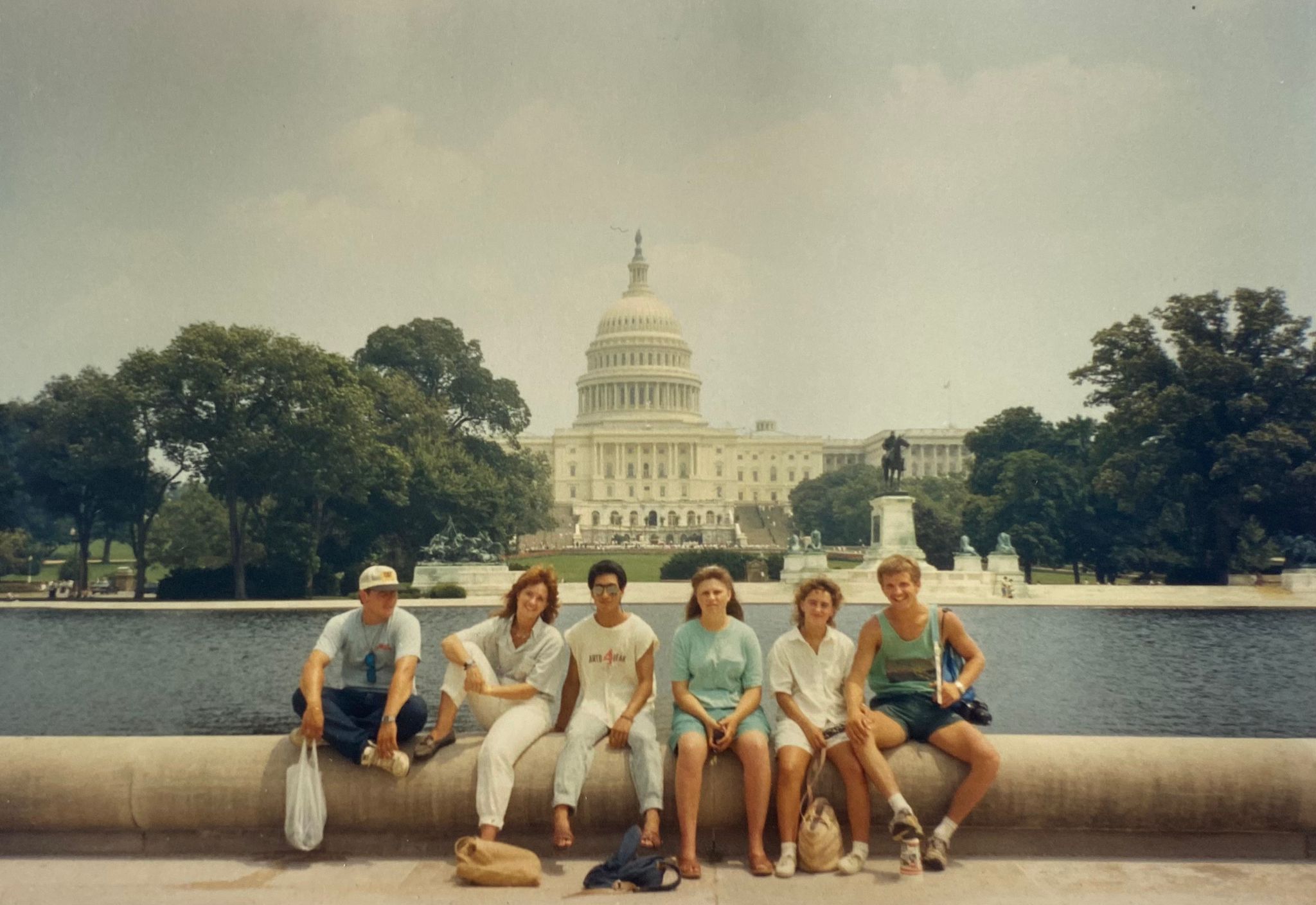 A group of young people sitting in front of the US Senate building