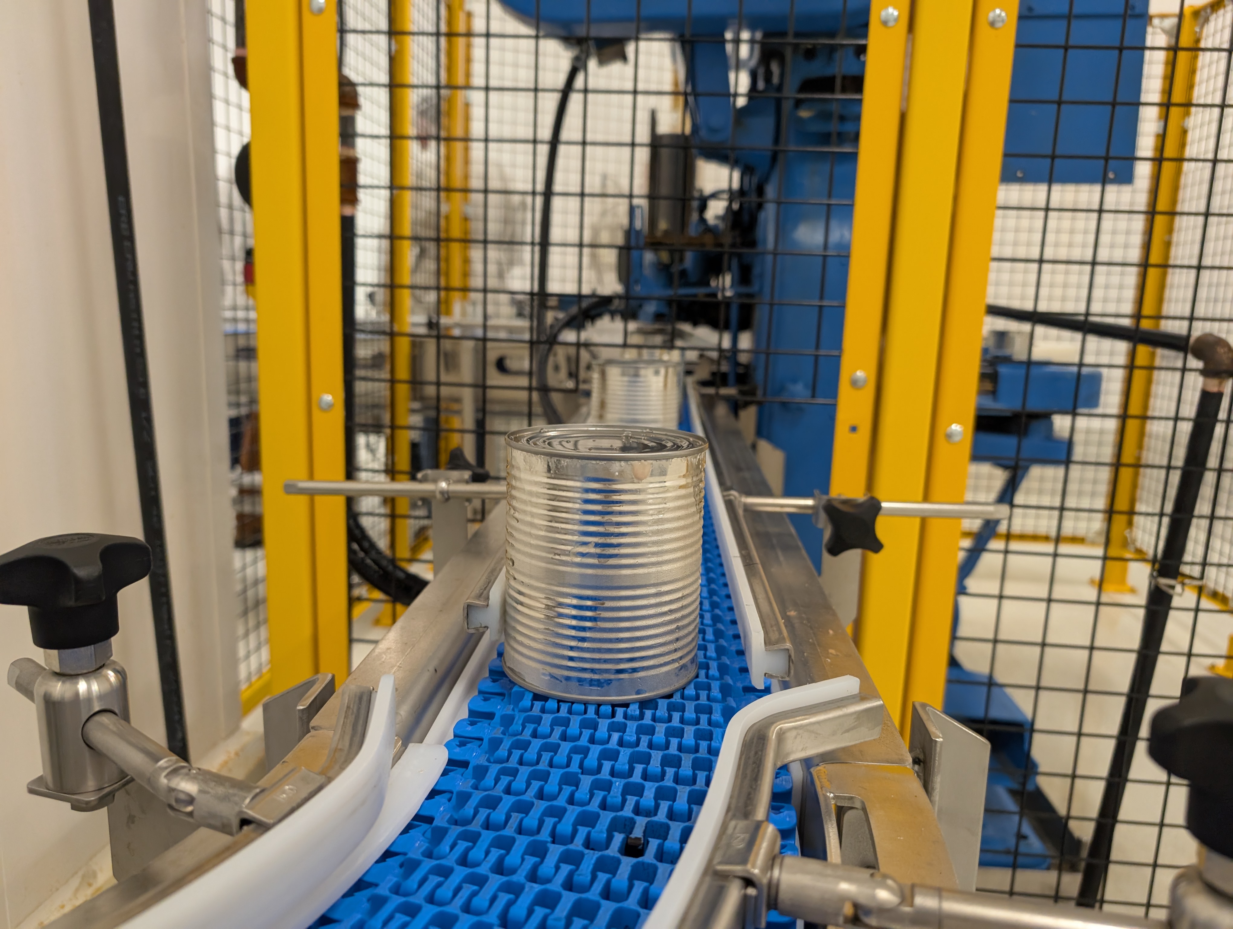 A can of meat makes its way along a conveyor belt at the meat cannery.