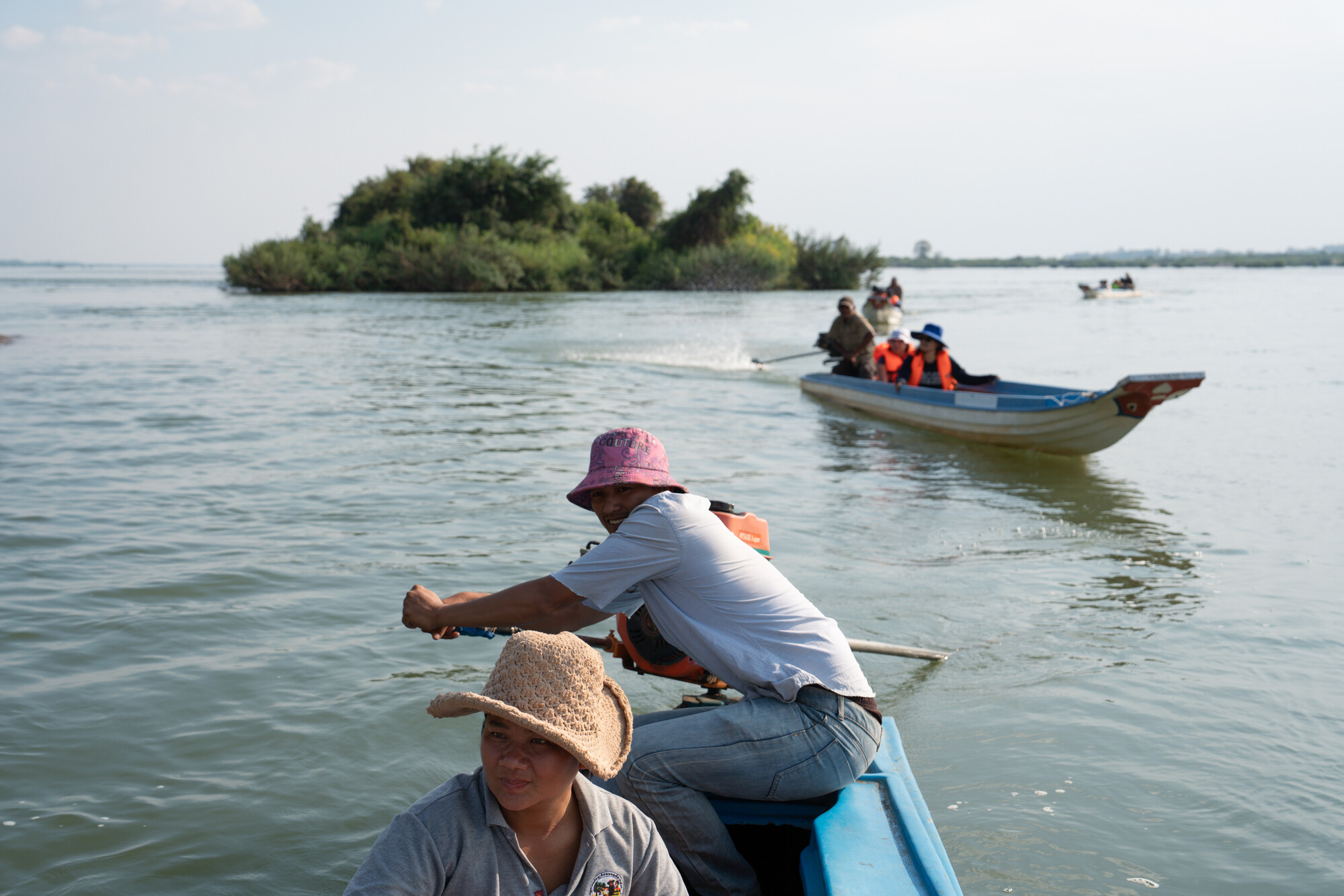 Kun Nora, 32, with Sor Navy, 36, steers the boat on a patrol along the Mekong River as they check for illegal fishing.