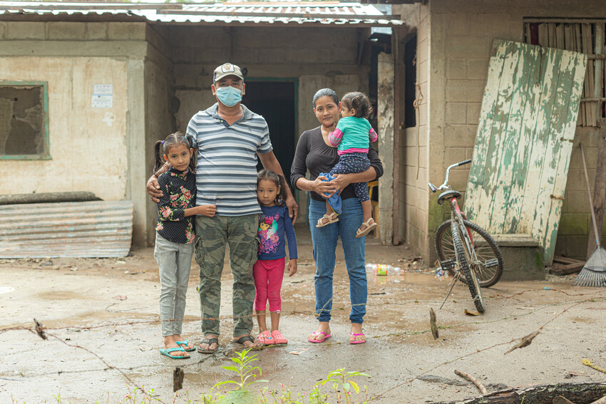 Amadeo Castillo stands with his wife Suyapa Arely Rivera Villanueva and their three children Maria, 8, Fernanda, 4, and Anita, 1, outside their newly rebuilt home. Castillo described the damage that H