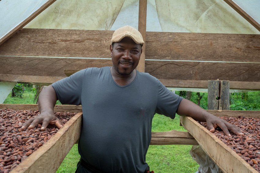 Luis Norberto Mosquera dries cacao seeds on his farm in the Lower San Juan region of Chocó, Colombia in 2018. Through a cacao project run by MCC partner Weaving Hope Agricultural Foundation (FAGROTES/