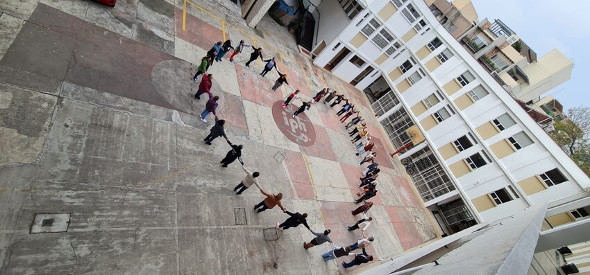 Relatives of disappeared people in Mexico hold hands, forming a heart, during the December 2023 national gathering of the Movement of Our Disappeared.