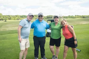 four people on golf green