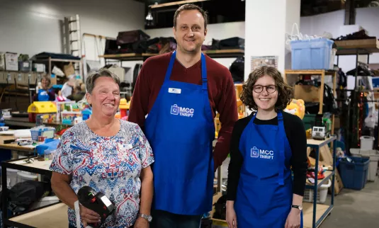 Volunteers Janice Wiggins (left), Alexander Germann (middle) and Lucia Dück (right) in the donation department of the Edmonton MCC Thrift Shop.