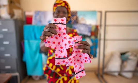 A woman holds up cloth pads
