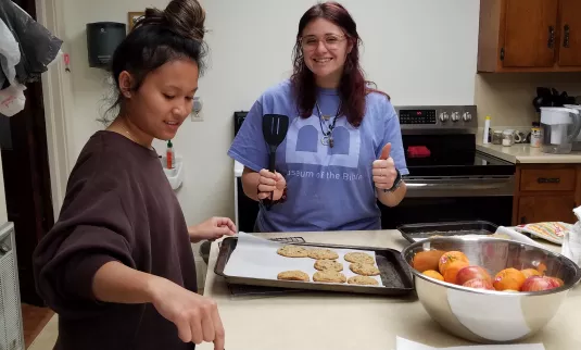 two young women baking cookies