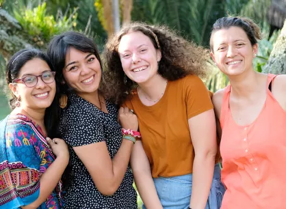 A group of four young women smiling for the camera