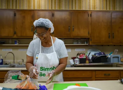 Carol Dunn prepares vegtables in the kitchen for volunteers to take to lunch on the Appalachia Build job sites.