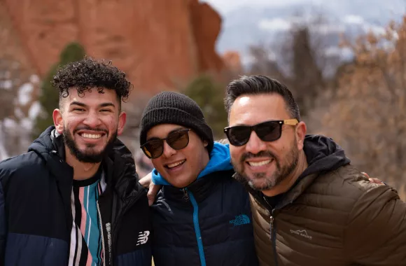 Three men in sunglasses looking at the camera