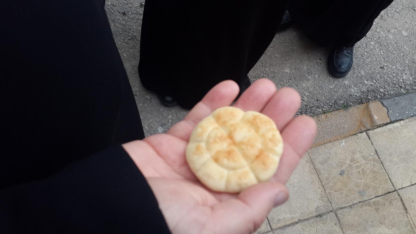 A piece of bread in someone's hand