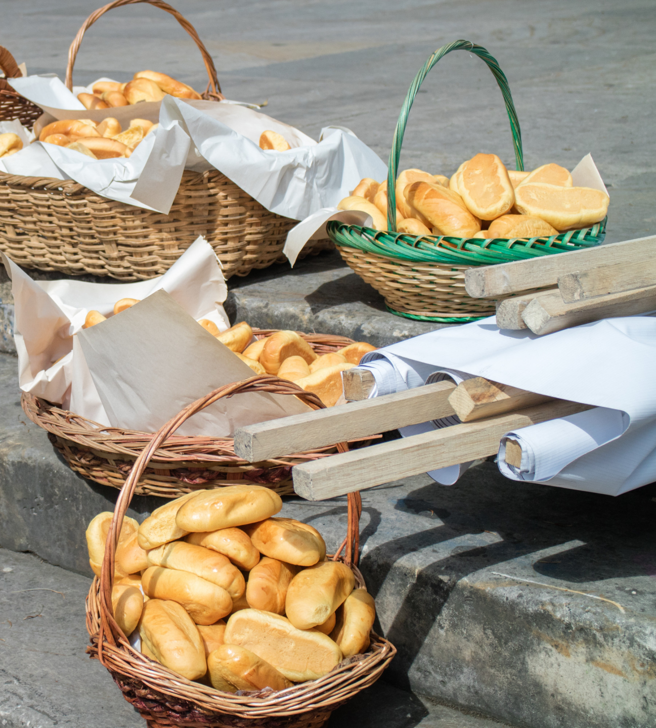 Baskets of bread sit on cement stairs outside